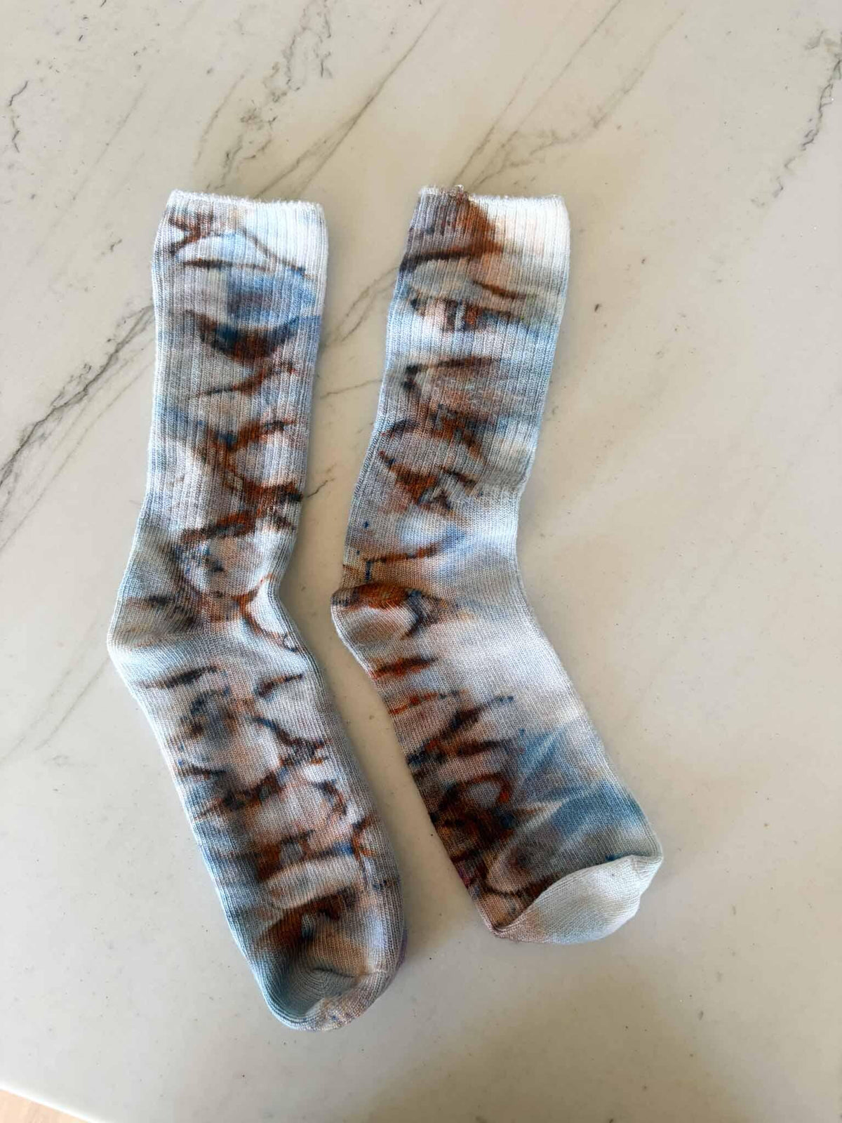 Pair of bamboo crew socks in rust and blue Pillars ice dye colorway laid flat __etsy:8501098128