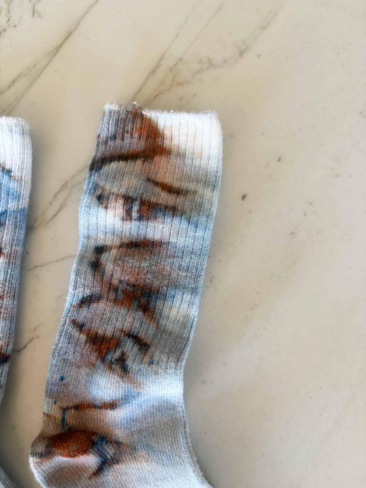 Close-up of sock cuff showing rust brown and blue scribble ice dye pattern __etsy:8501098124