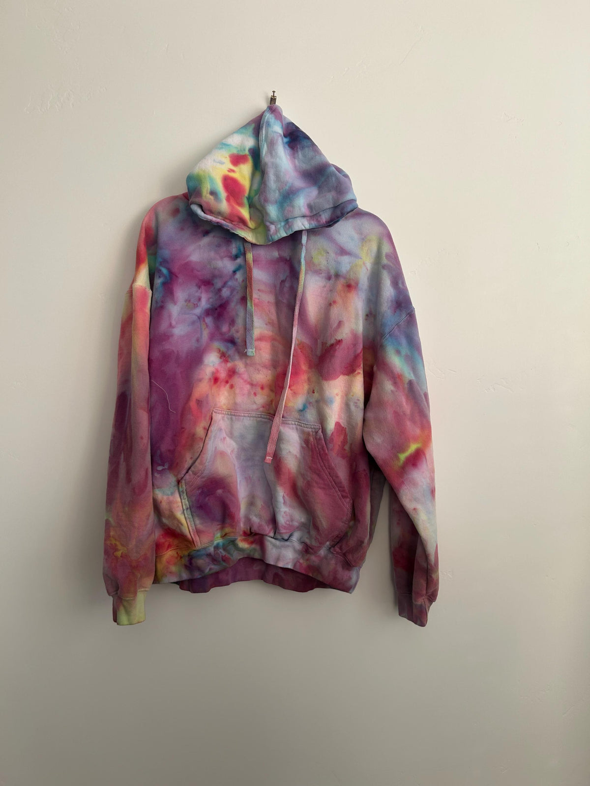 Hand-dyed watercolor ice dye hoodie in soft pink  and purple. A unique boho-chic cotton sweatshirt,  perfect as a one-of-a-kind gift for her or artistic  festival wear.