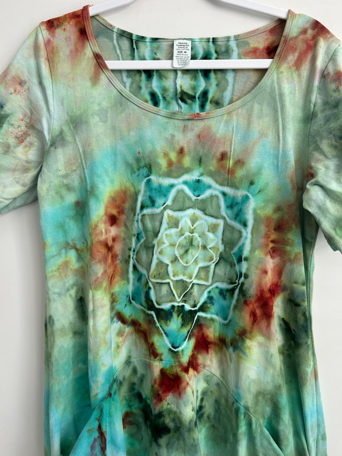Close-up of mandala ice dye design on hand dyed cotton dress – earthy teal green rust geode center detail – one of a kind boho wearable art