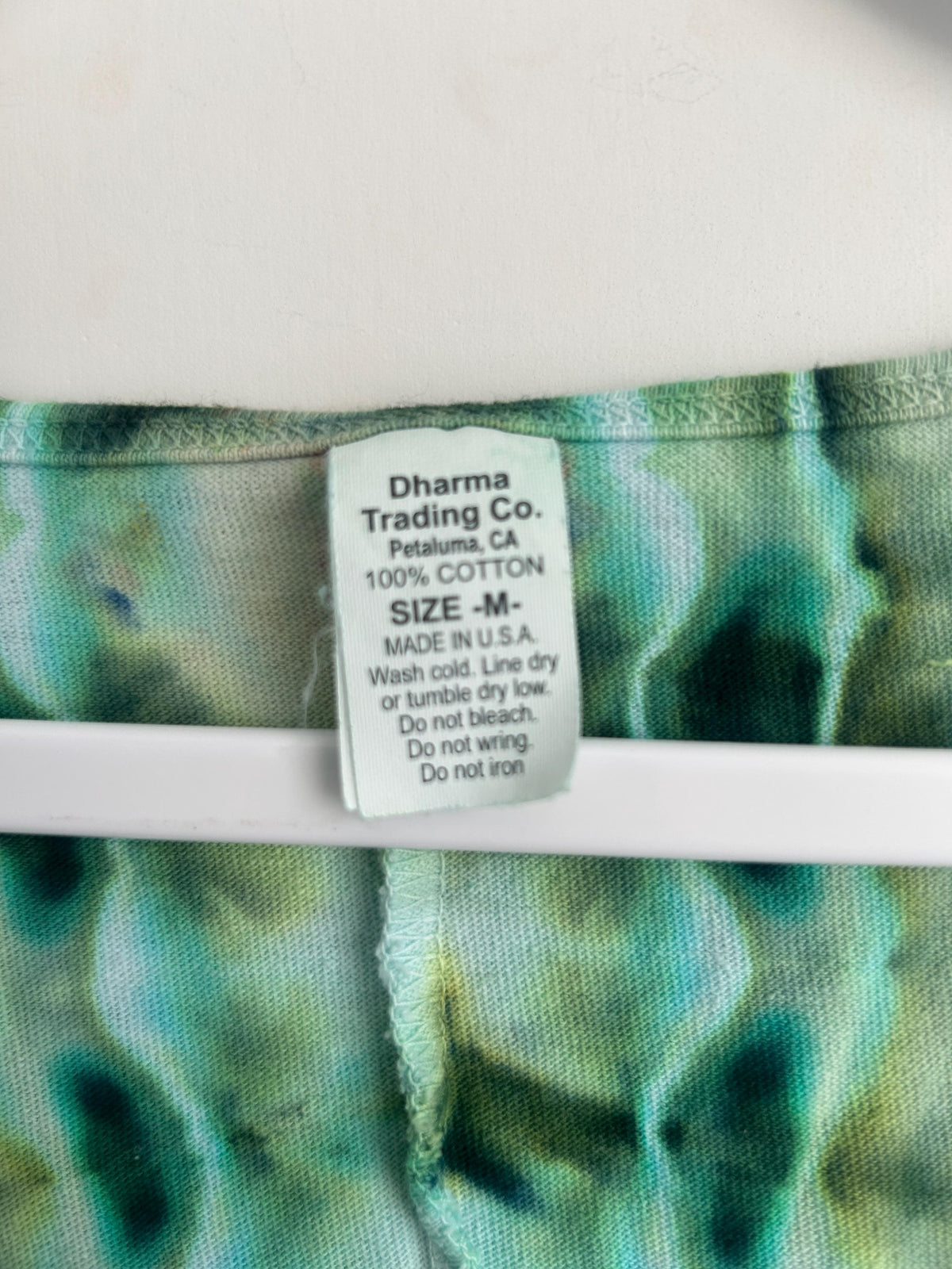 Size M Dharma Trading Co cotton dress tag showing material and sizing information