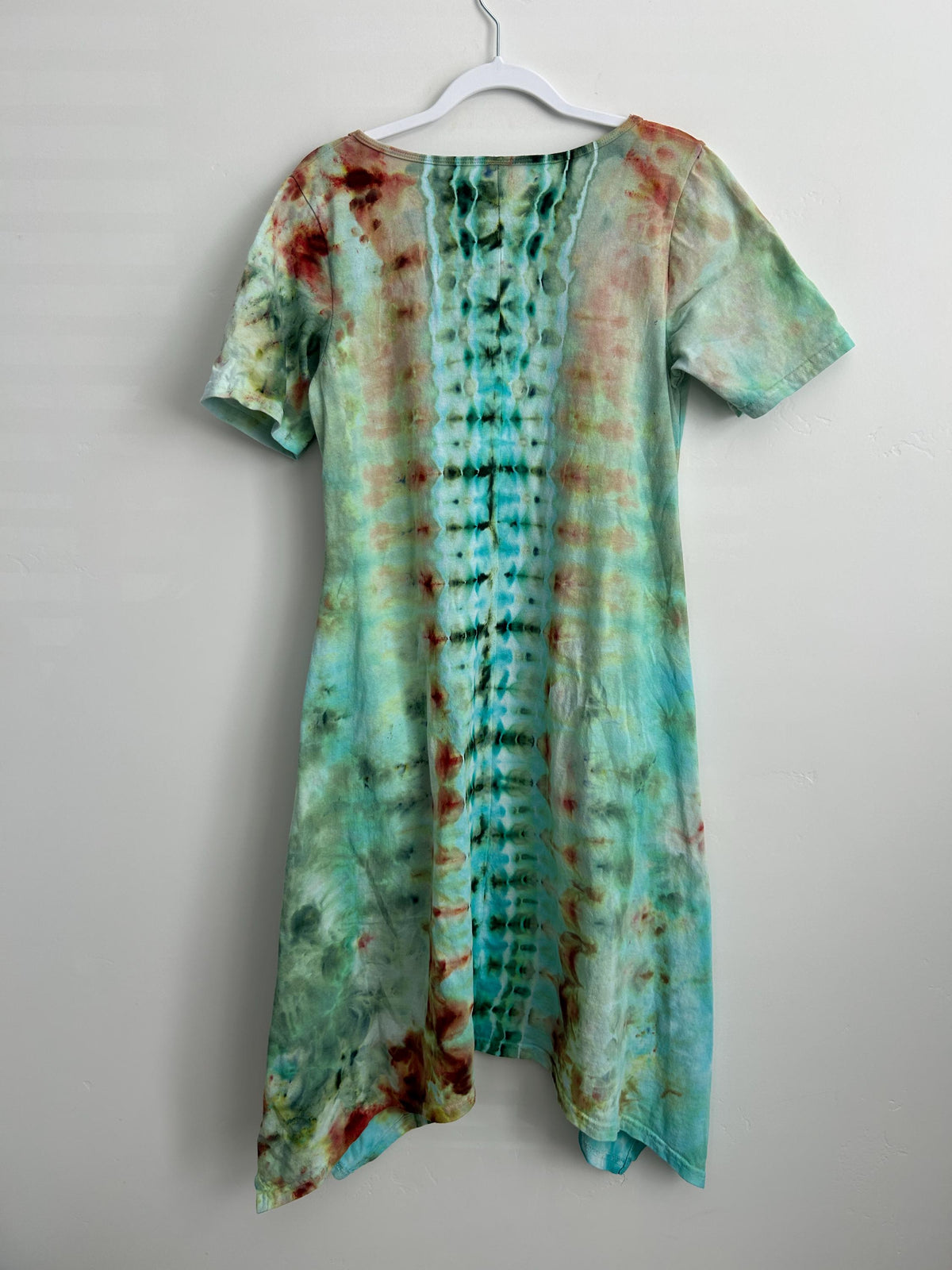 Hand dyed mandala ice dye dress back view in teal green and rust – earthy cotton boho dress showing vertical spine pattern – one of a kind wearable art size medium
