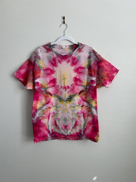 Hand-dyed ice dye t-shirt in blush pink, hot pink, and golden yellow. Mirrored floral watercolor pattern on 100% cotton, one-of-a-kind artisan tie dye tee, size L.