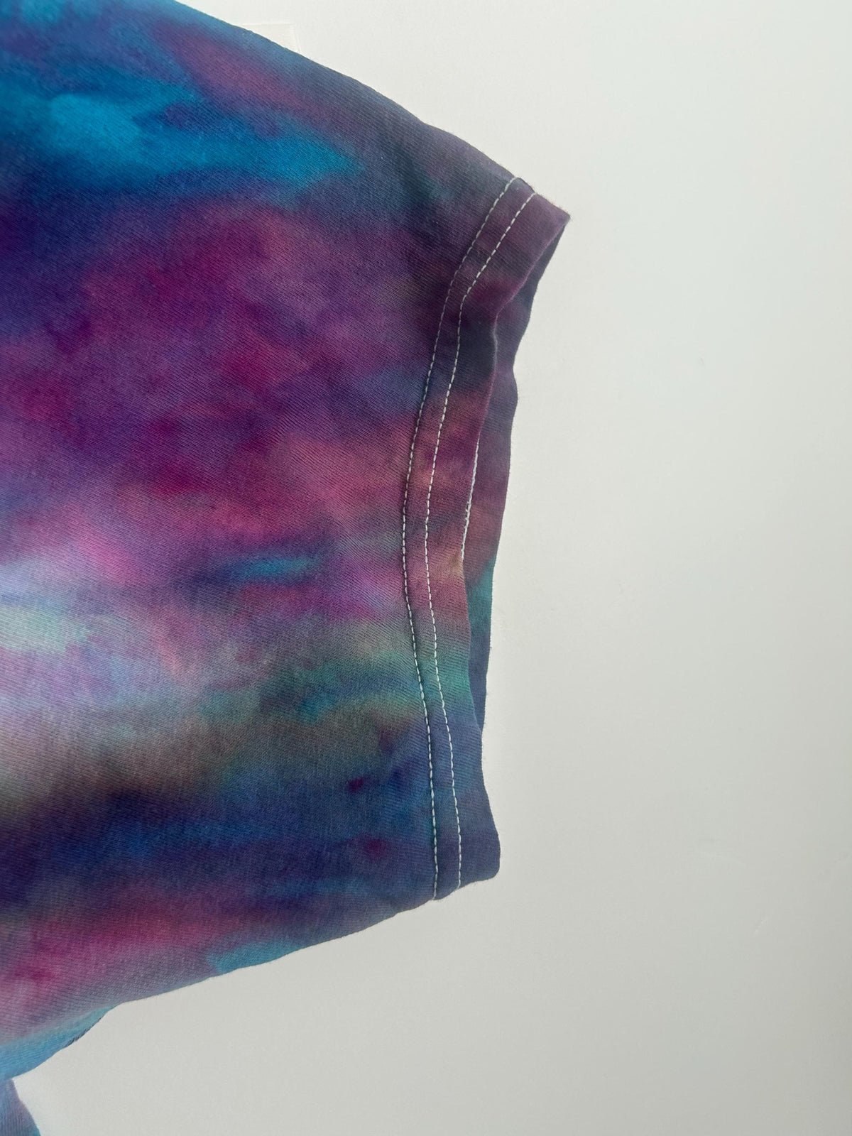 Close-up of the sleeve showing the plum, magenta, and teal color blending
