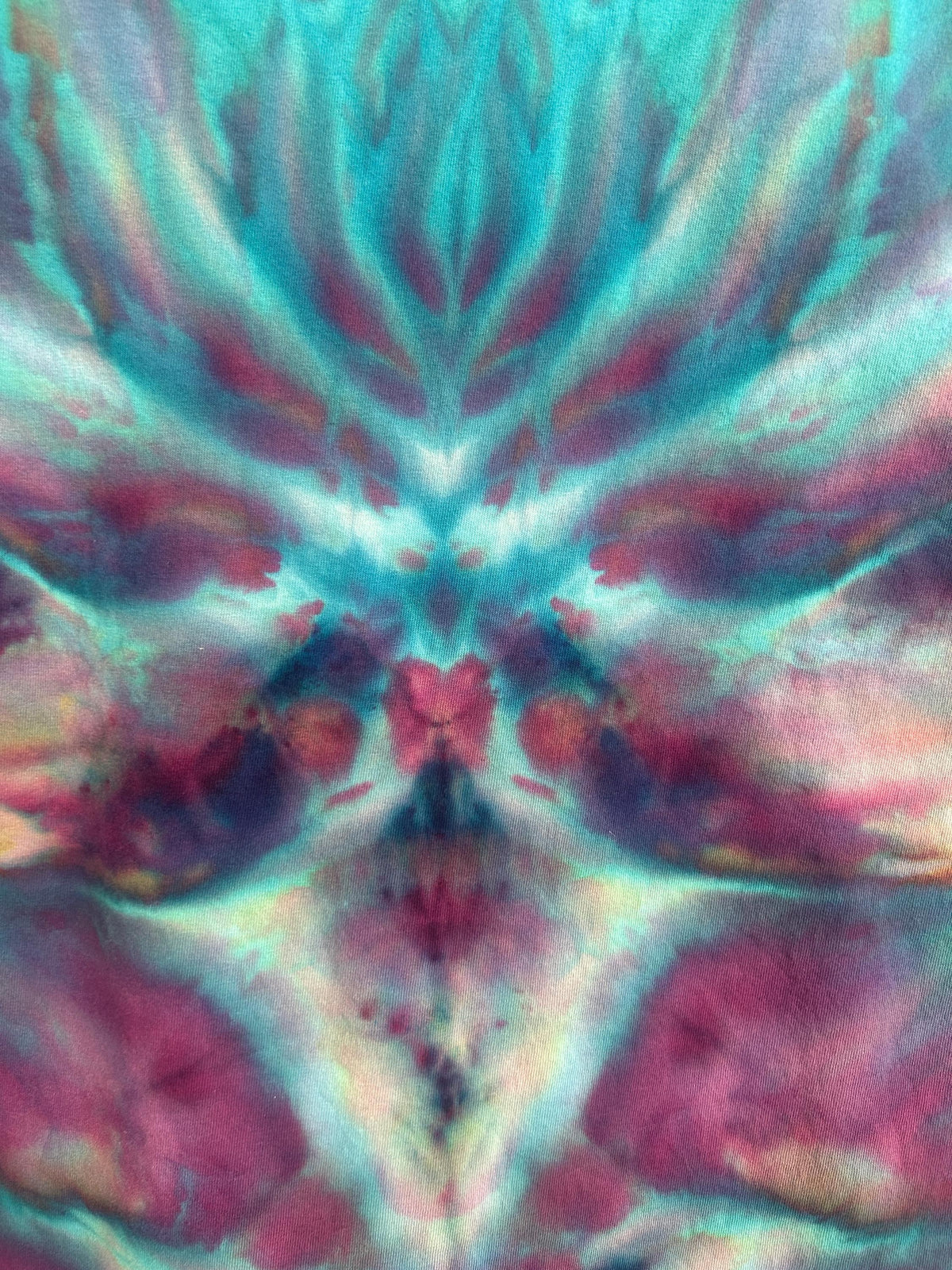Macro detail shot of the ice dye pattern showing teal, magenta, and gold color variation