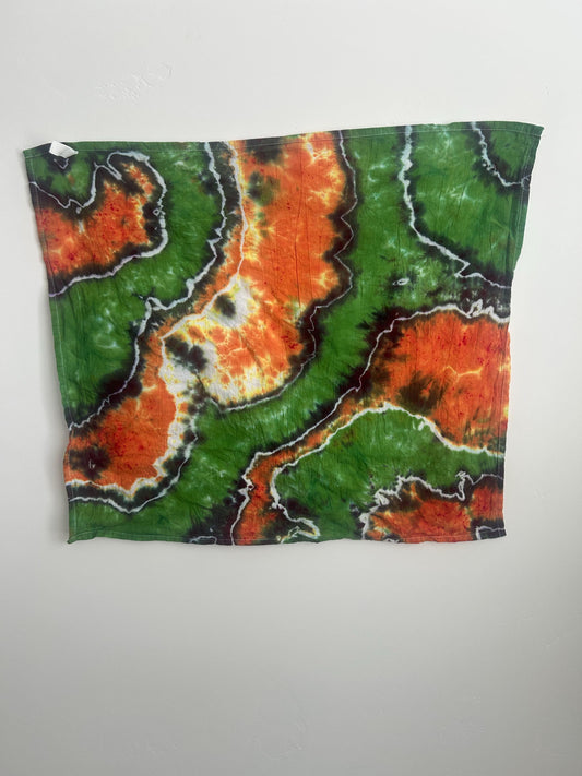 Hand dyed cotton tea towel with geode pattern in green and orange, 27x27 inches