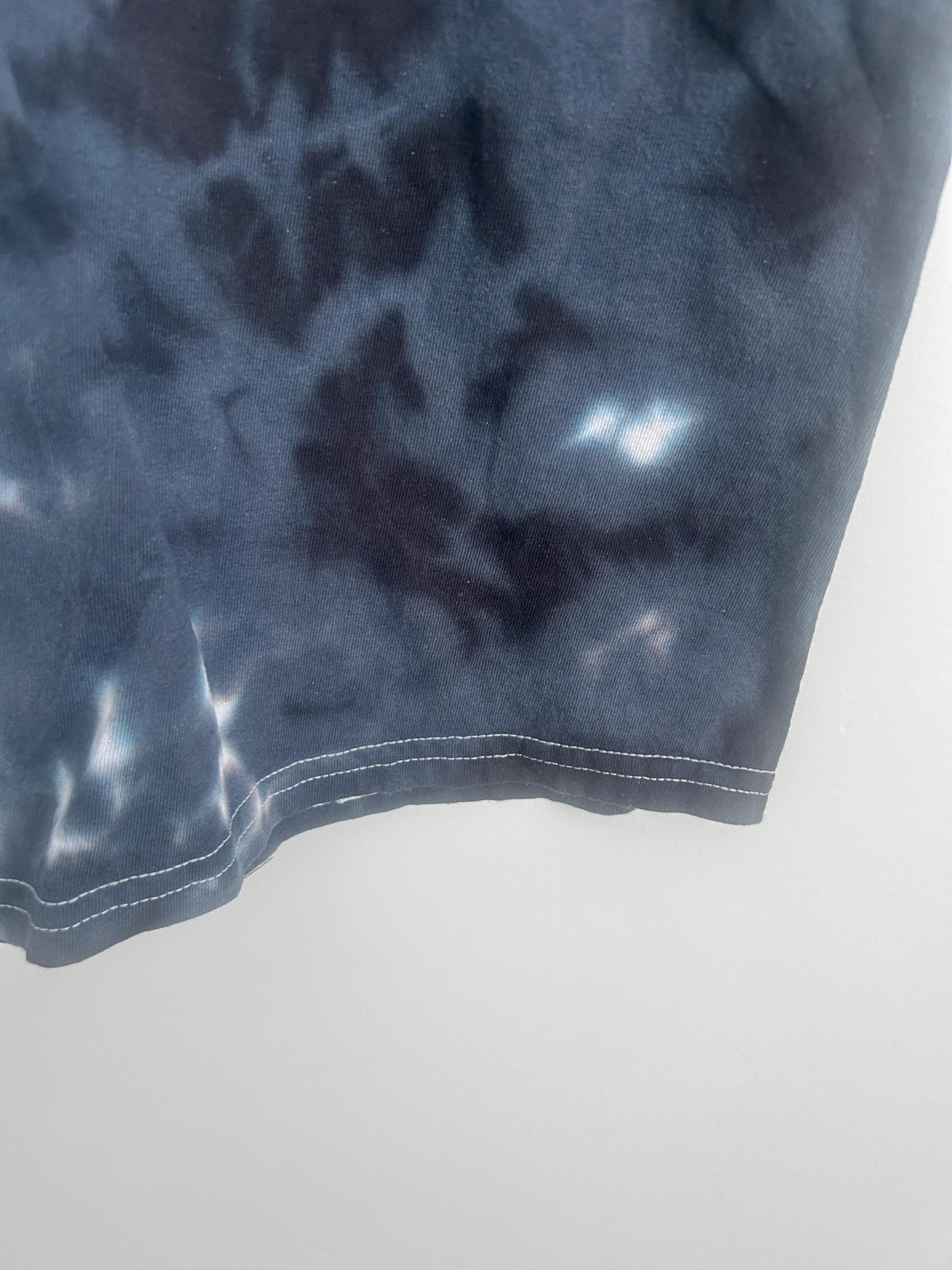 Hem detail of hand dyed black and white bullseye tie dye t-shirt