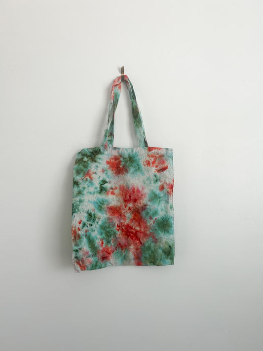 Back view of coral and teal tie dye canvas tote showing watercolor pattern variation