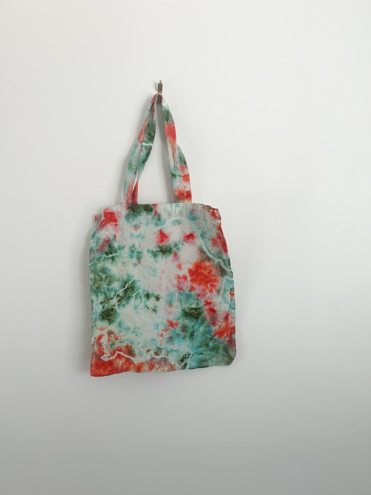 Hand dyed canvas tote bag in coral and teal with bright coral center bloom