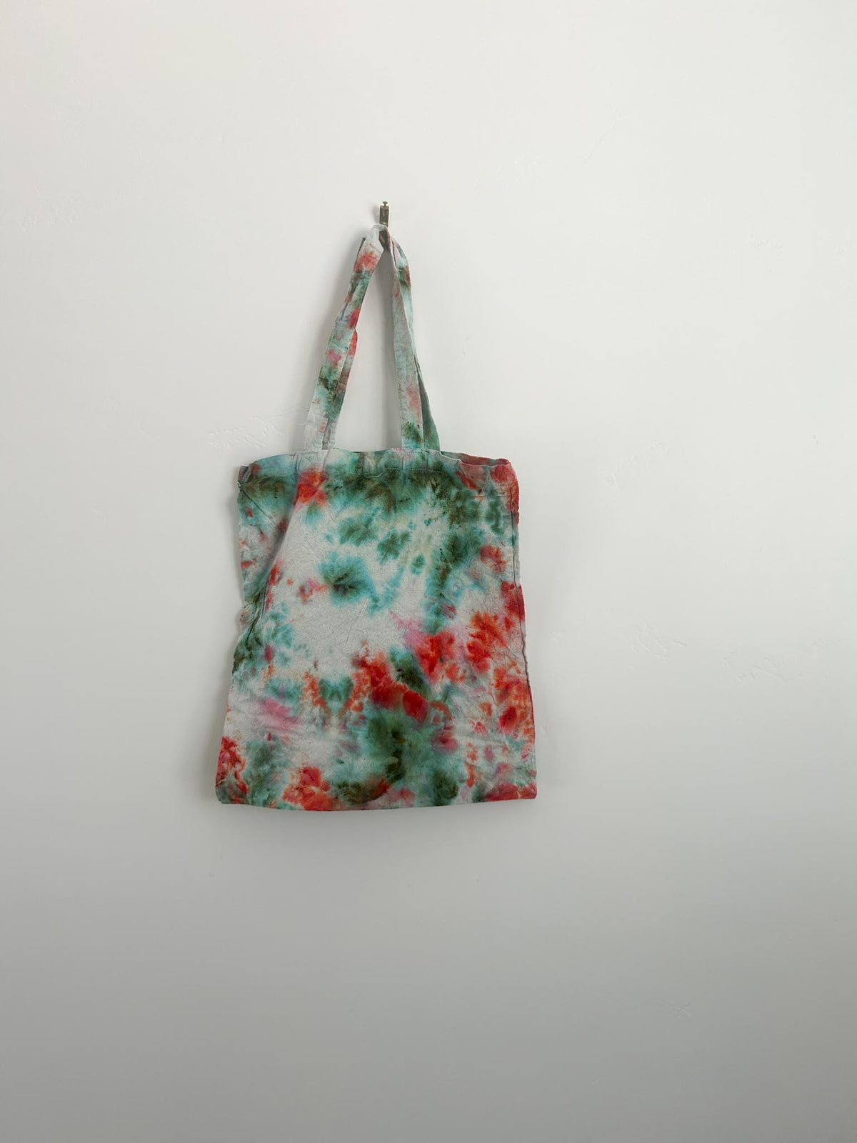 Hand dyed canvas tote bag in coral and teal with bright coral center bloom