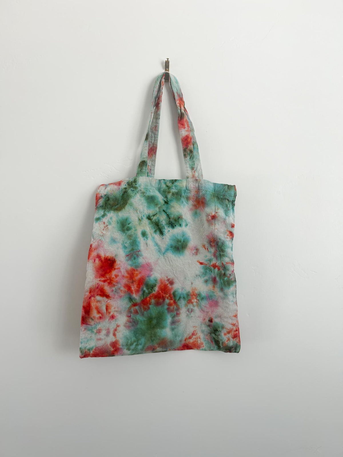 Ice dye canvas tote bag with coral, pink, and teal wildflower pattern on cotton