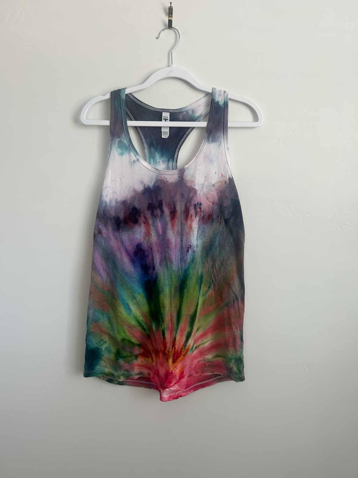 Fan fold ice dye tank top in purple ombre and rainbow burst, full front view on hanger