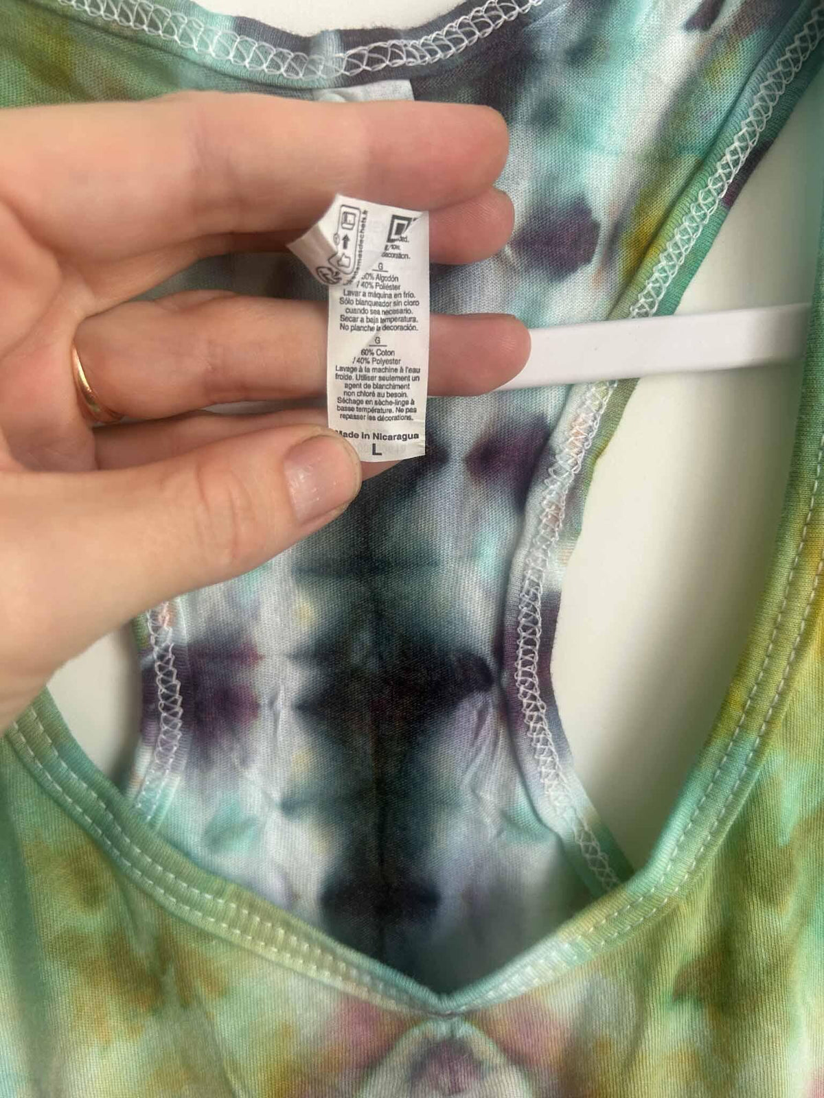 Tank top care tag showing 60% cotton 40% polyester, made in Nicaragua, size L