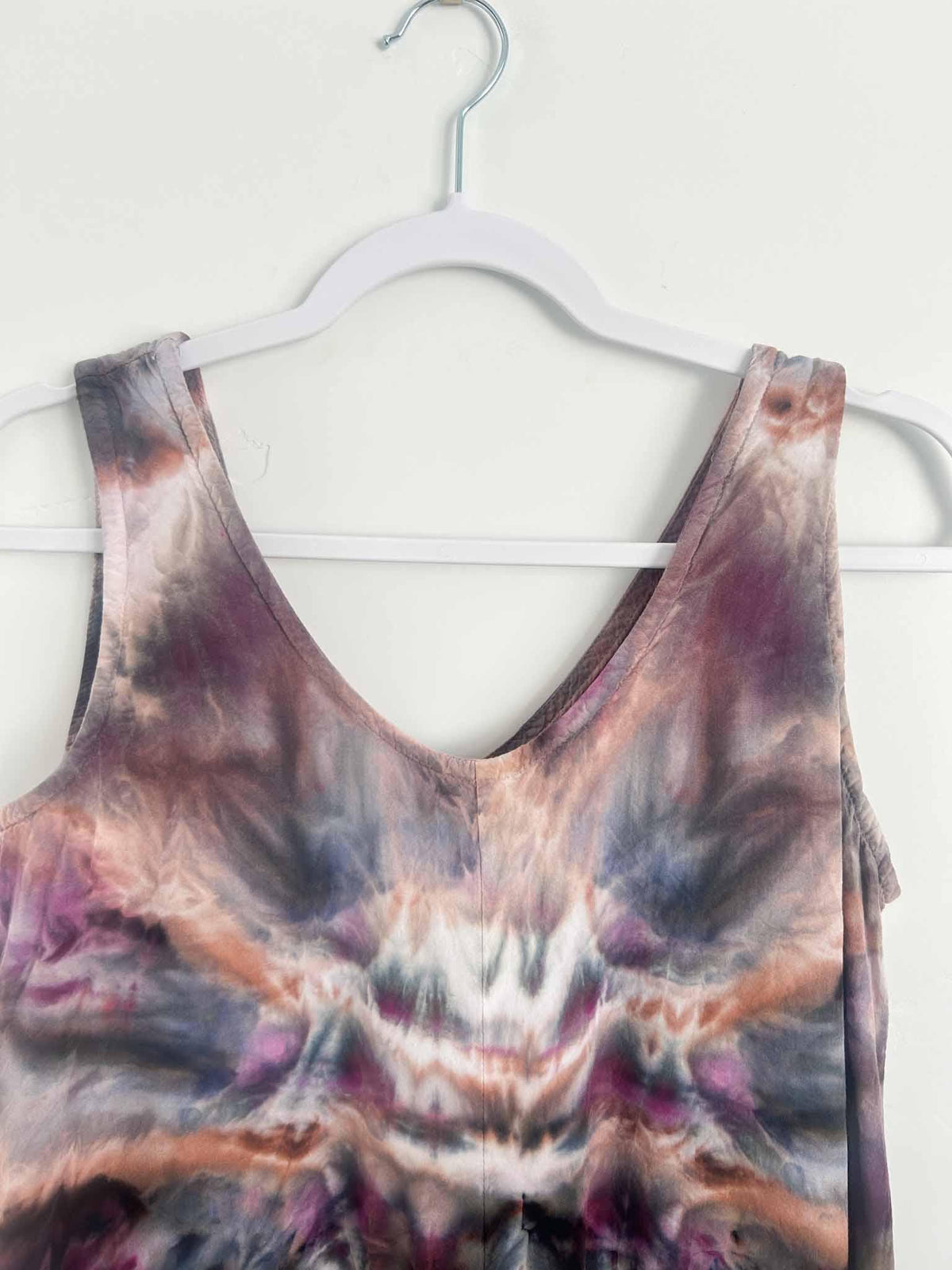 Close-up of ice dye rayon dress shoulder and V-neckline in plum and rust