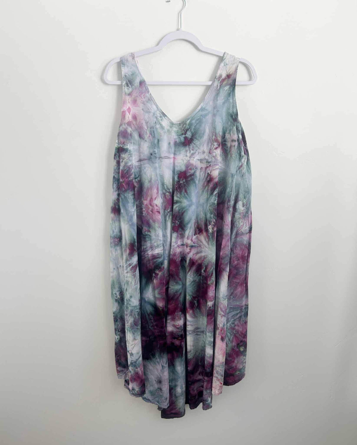 Ice dye hi-lo rayon dress in purple and teal floral pattern, full front view on hanger