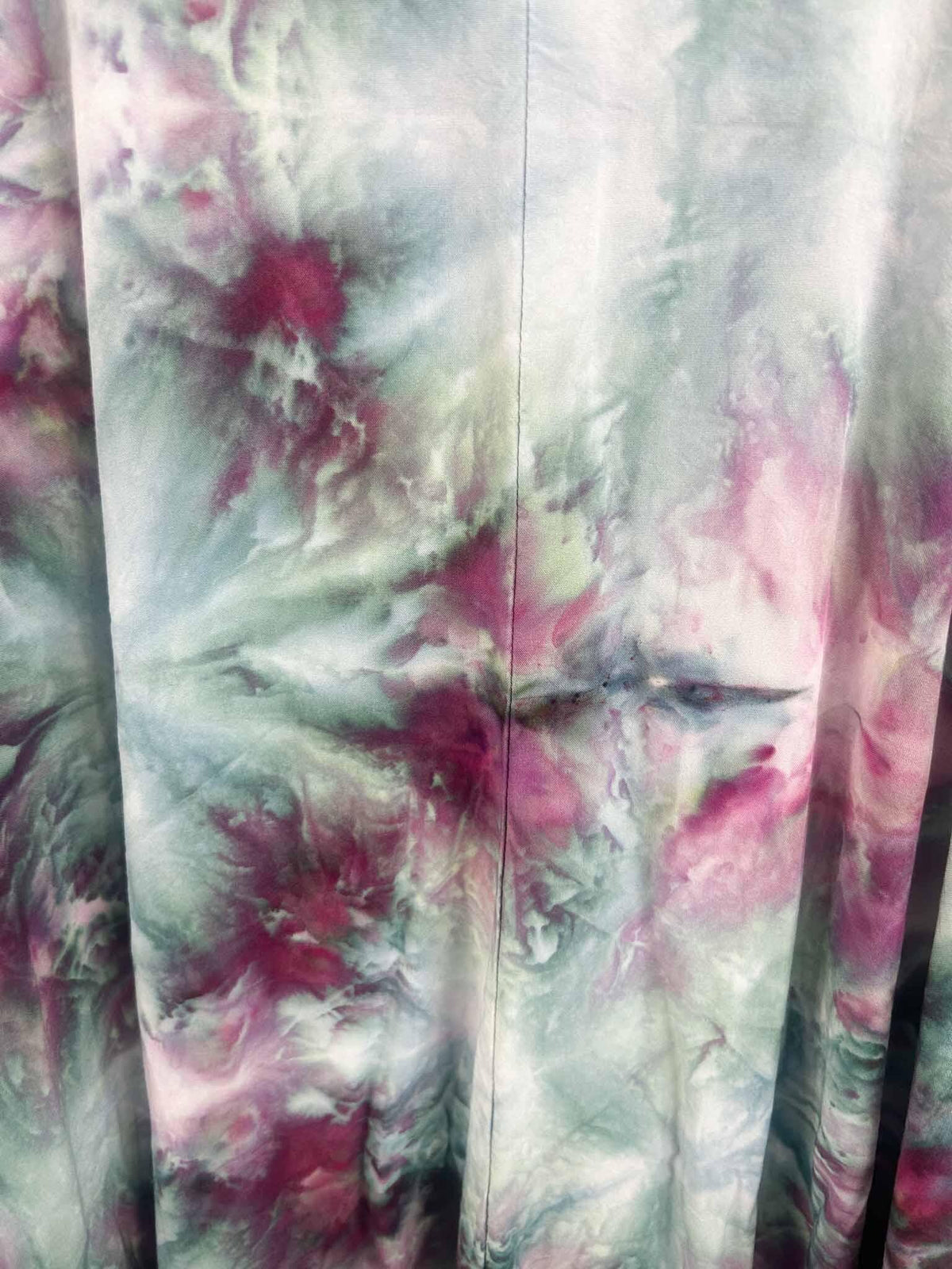 Close-up of ice dye hi-lo dress hem showing layered purple and grey color blending