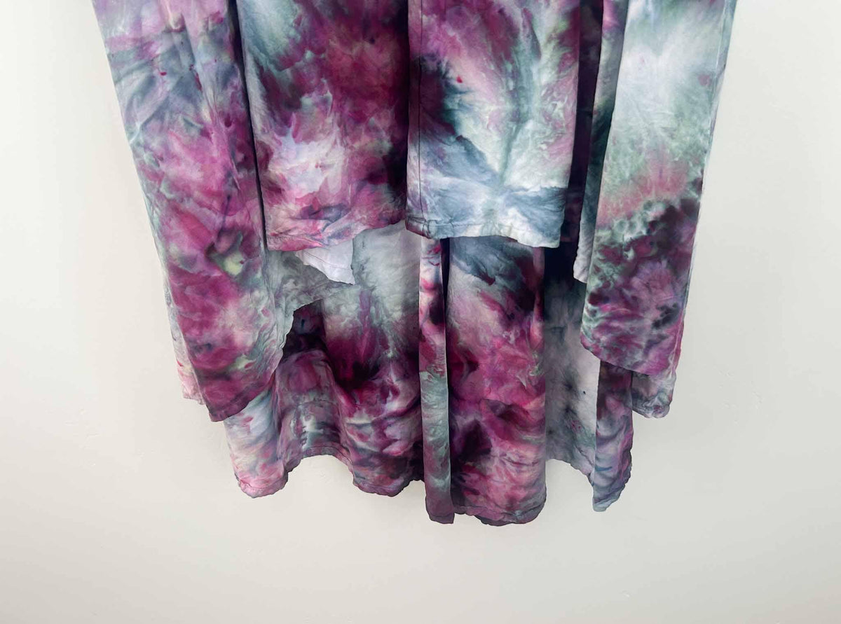 Close-up of ice dye rayon dress skirt showing sage green, magenta, and teal color blending