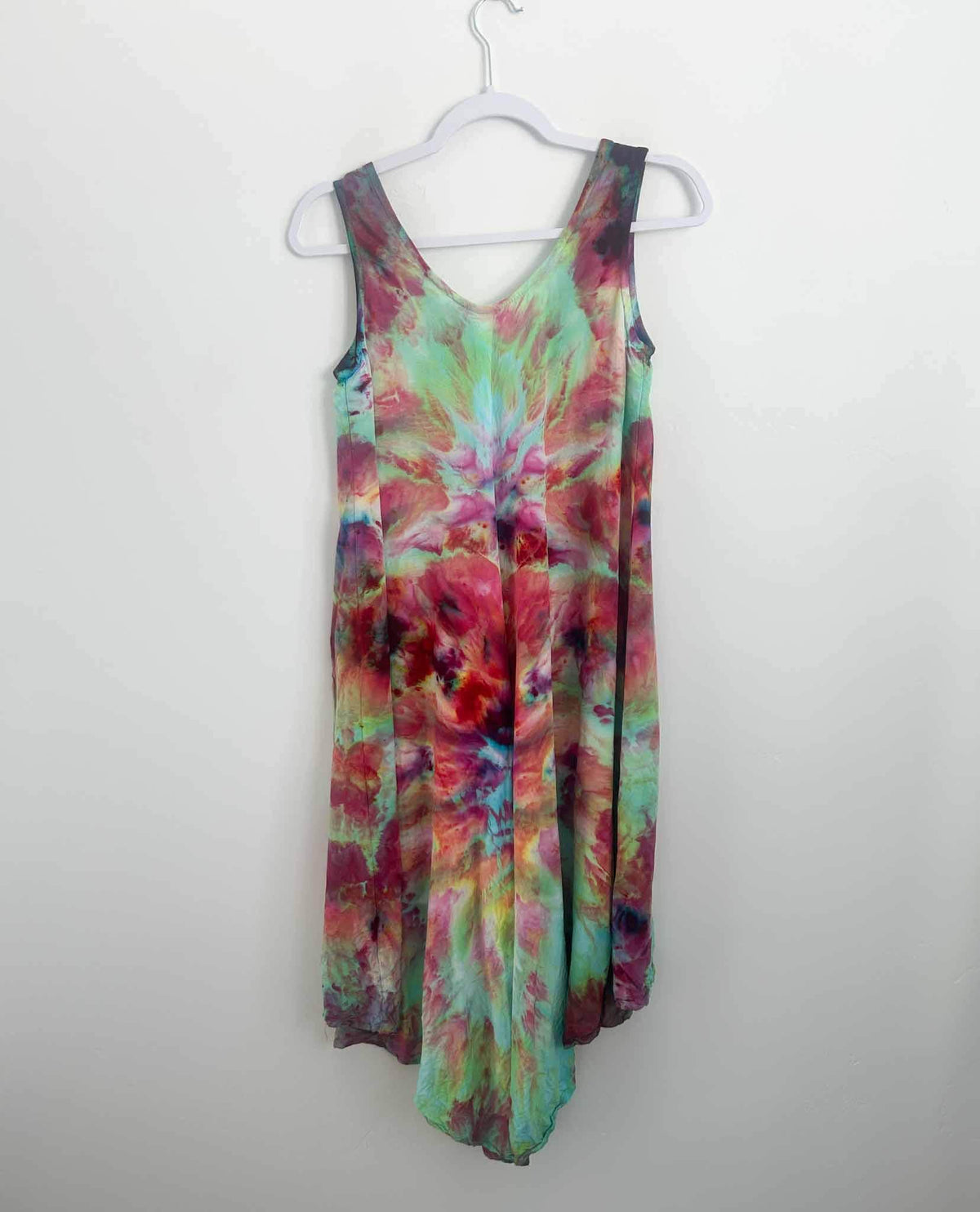 Rainbow ice dye deity roll rayon hi-lo dress in pink and mint, full front view on hanger