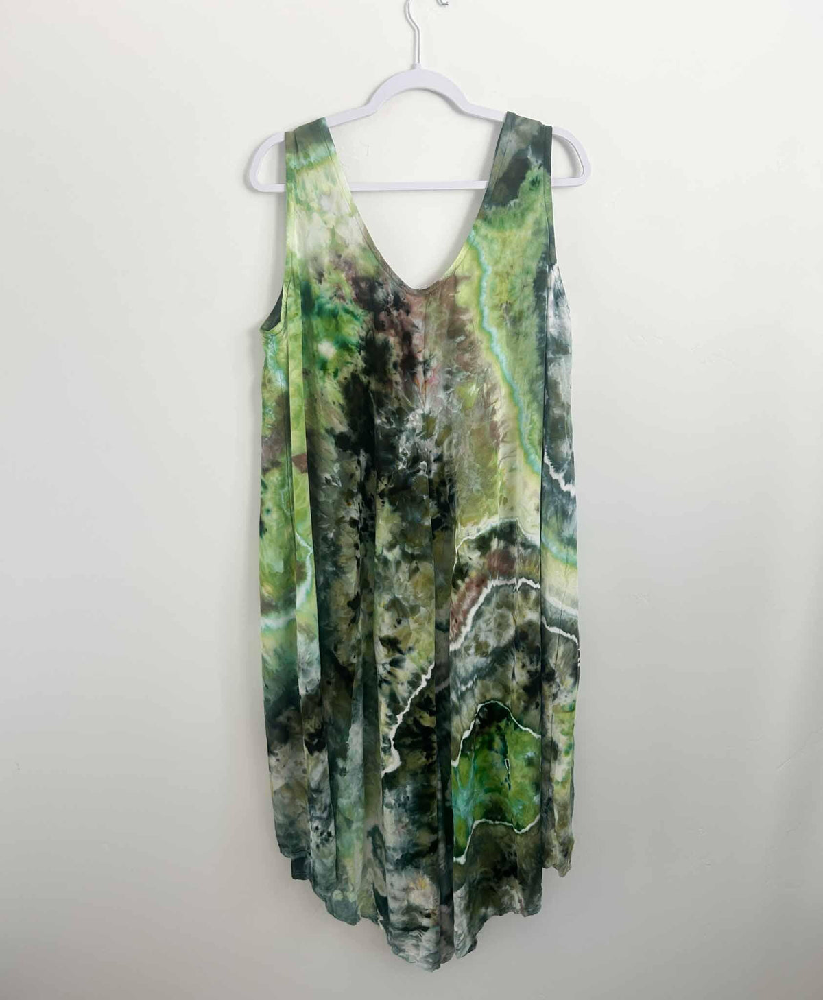 Green geode ice dye rayon hi-lo dress showing crackle vein detail, back view on hanger