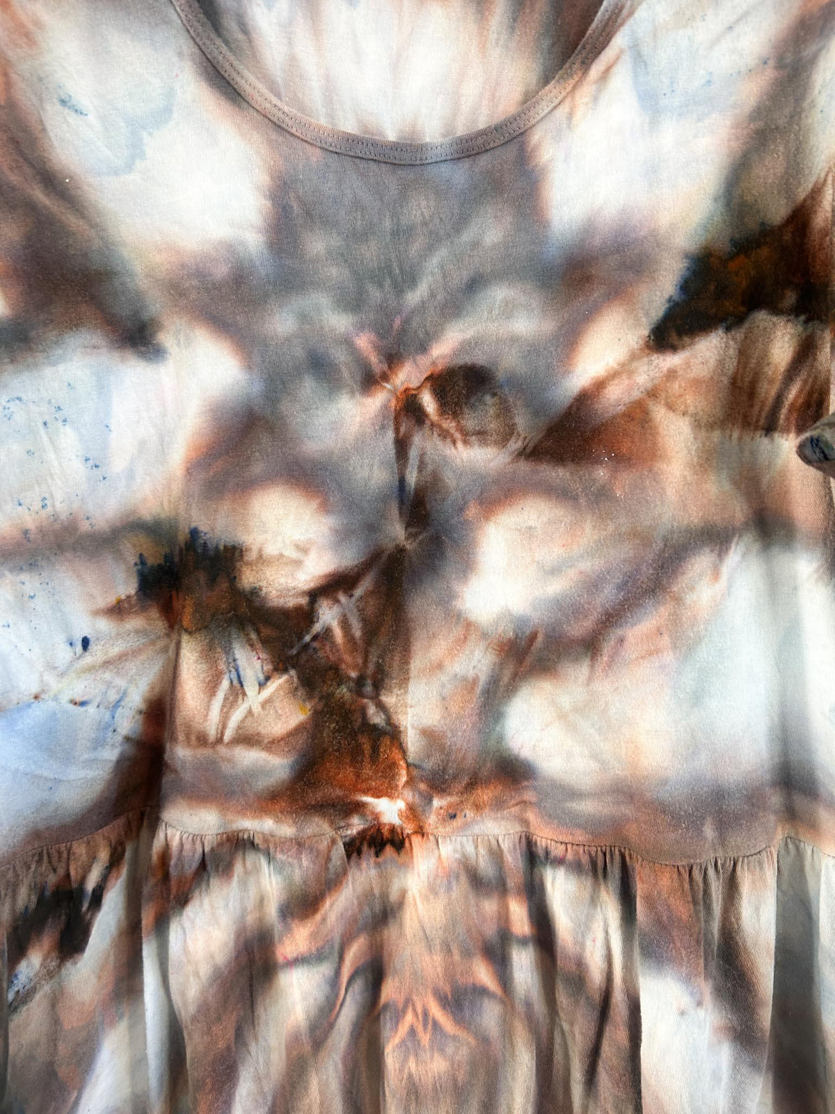 Close-up of ice dyed dress bodice showing rust, charcoal, and dusty blue starburst pattern