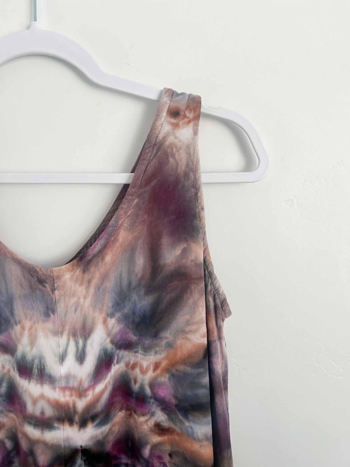 Close-up of ice dye deity roll pattern on rayon dress bodice in plum and rust