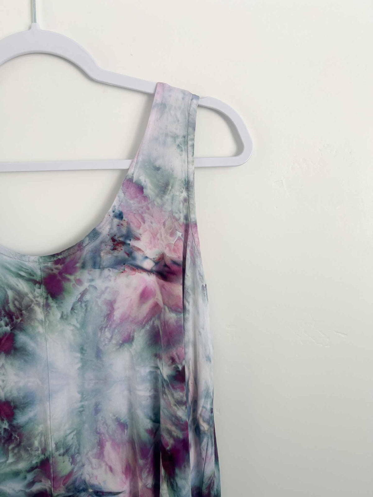 Close-up of ice dye rayon dress shoulder and V-neckline in purple and teal