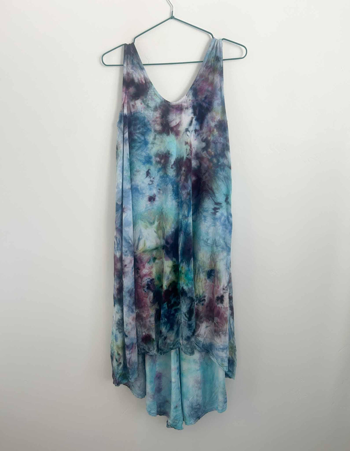 Ice dye hi-lo rayon dress in plum and teal scrunch pattern, full front view on hanger