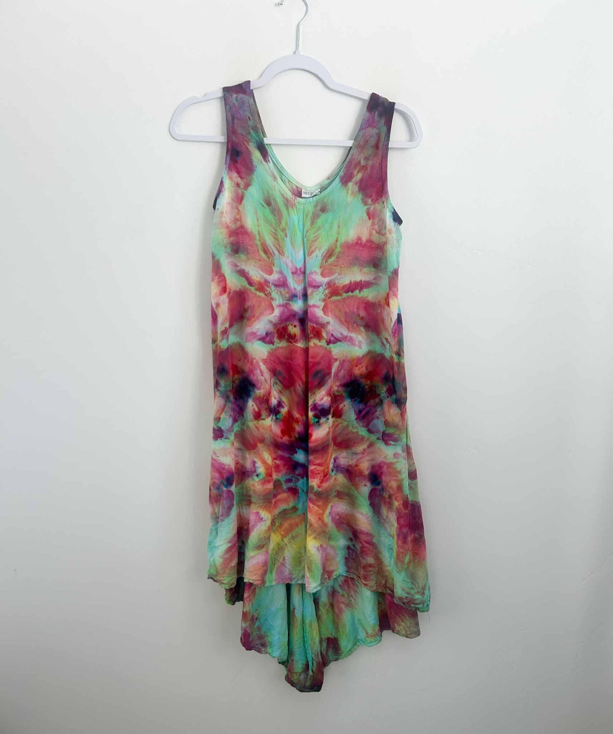 Rainbow ice dye deity roll rayon hi-lo dress in pink and mint, full back view on hanger