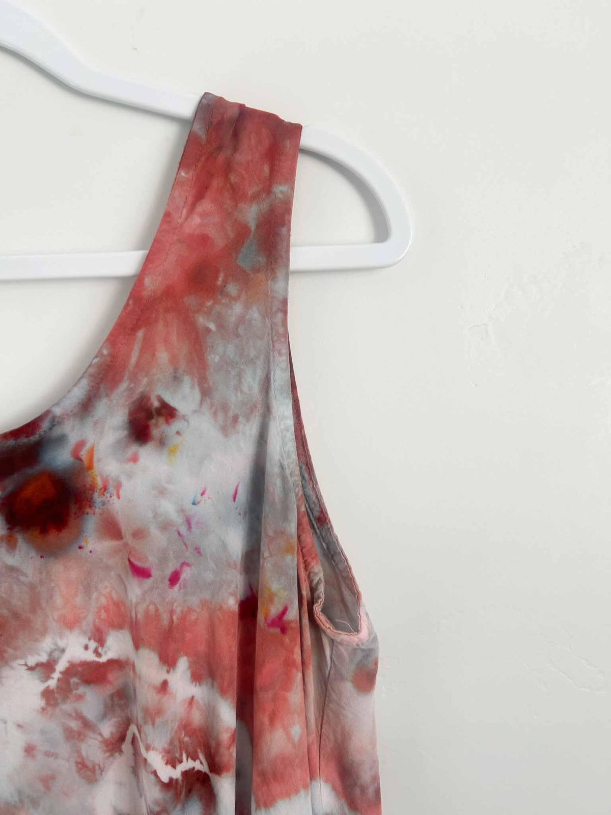 Close up of dress shoulder strap showing deep red and gray ice dyed geode pattern detail