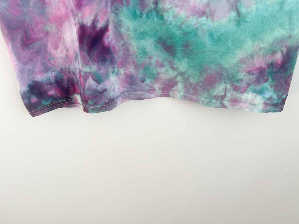 Close up of purple and teal tie dye pattern on shirt hem