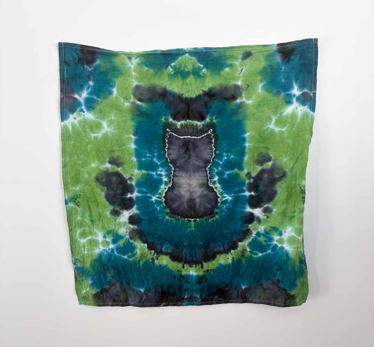 Black cat tie dye tea towel hanging flat, teal green background, 27x27 cotton