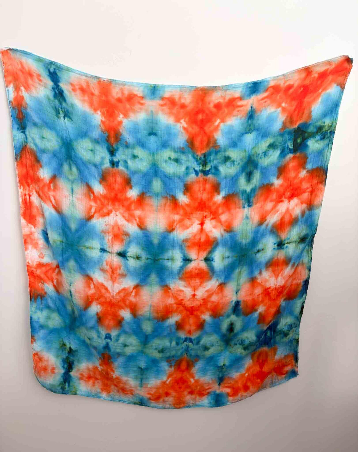 Tie dye bamboo gauze swaddle blanket in orange and blue diamond mandala pattern, 47x47 inches