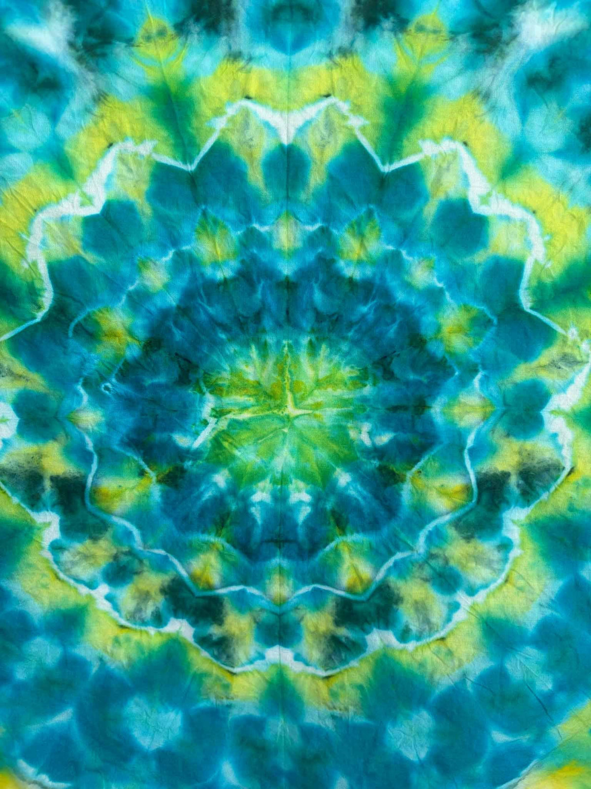 Green and blue ice dye mandala bandana close up, teal turquoise tie dye pattern on 22x22 cotton