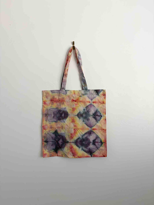Gold, plum, and coral shibori diamond grid ice dye tote bag hanging, 100% cotton canvas with handles