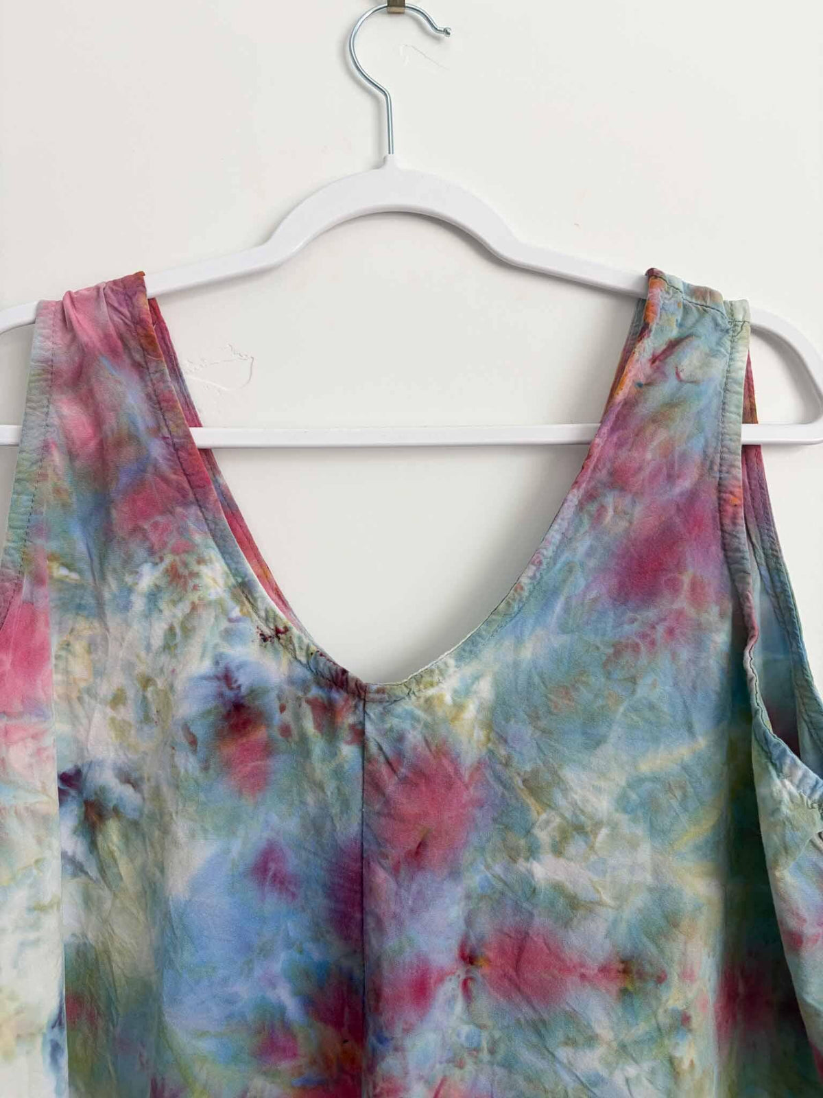 Close-up of V-neck on rose and sage tie dye tank dress