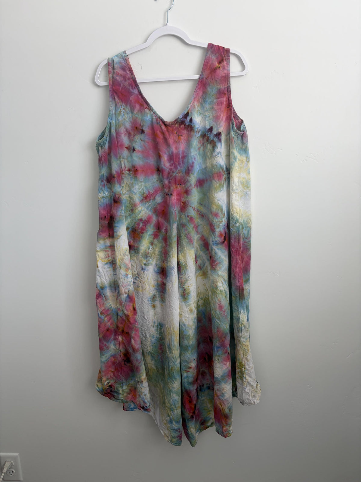 Full view of XL tie dye tank dress in rose, sage, and blue on hanger