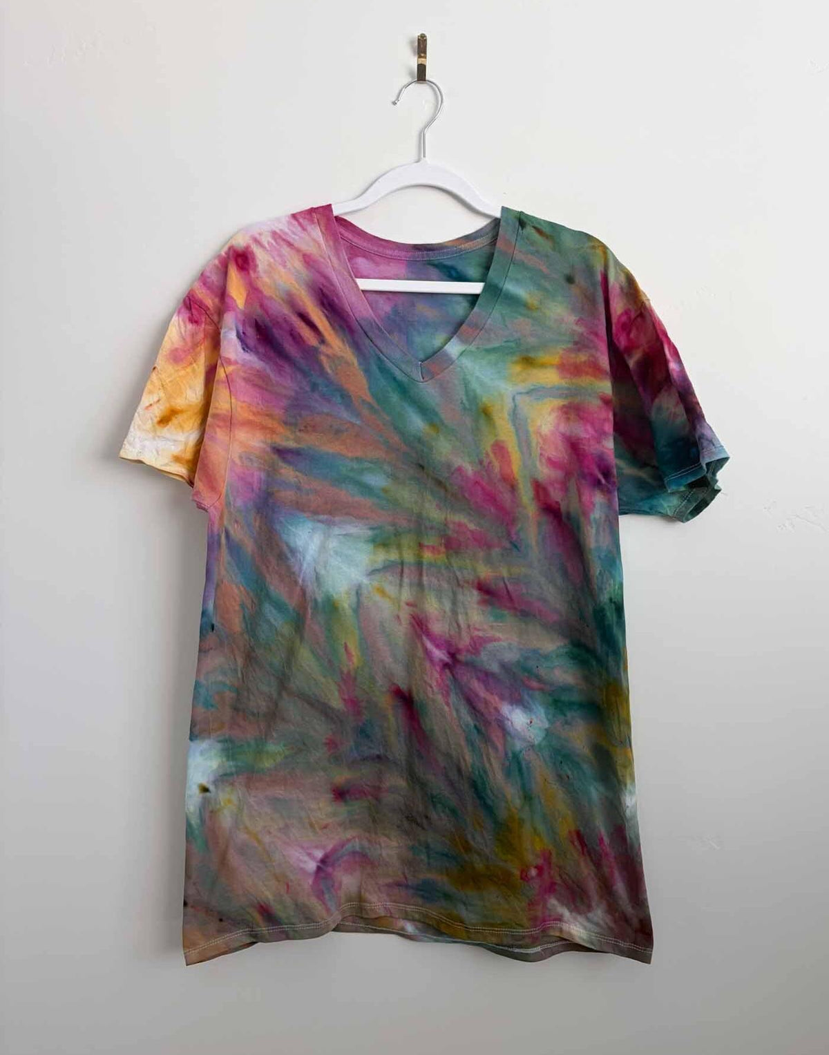 Rainbow ice dye fern fold v-neck shirt front view on hanger tie dye pattern