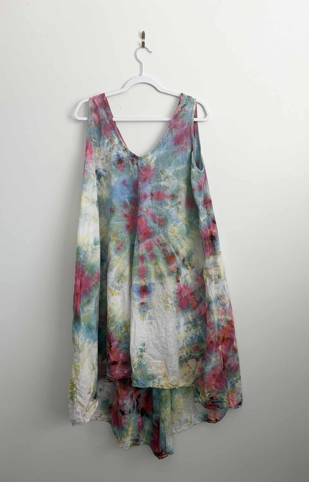 Full view of XL tie dye tank dress in rose, sage, and blue on hanger