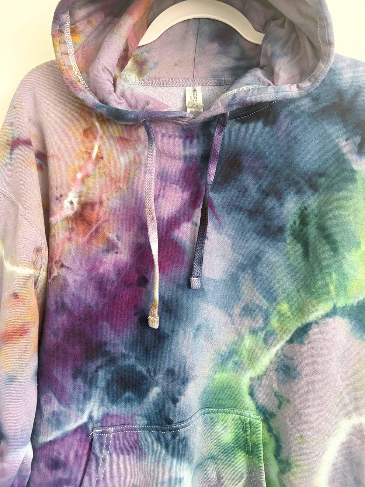 Close up of hood and drawstring on XL rainbow ice dye tie dye hoodie