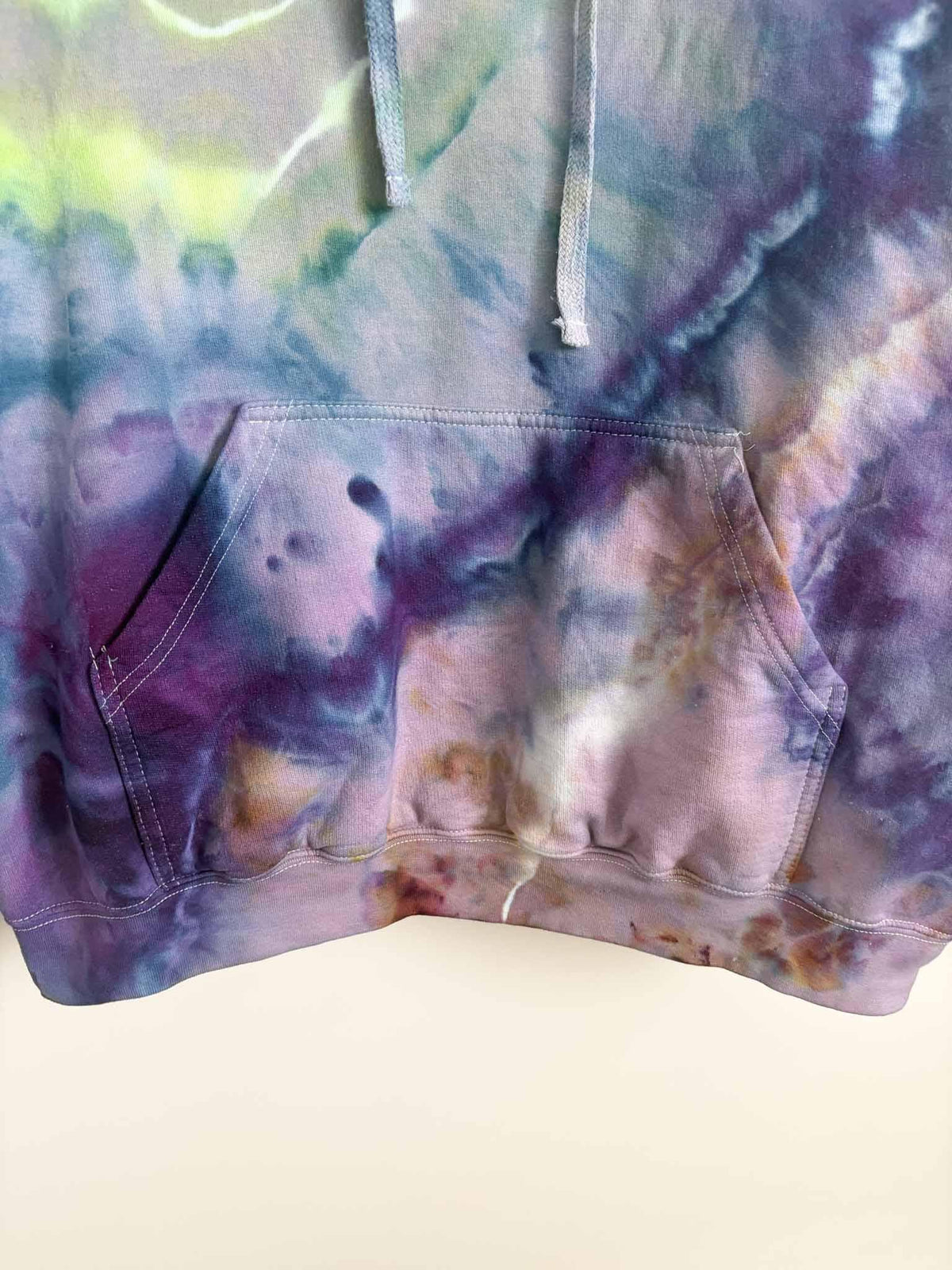 Close up of kangaroo pocket and hem on XL purple and gold ice dye tie dye hoodie