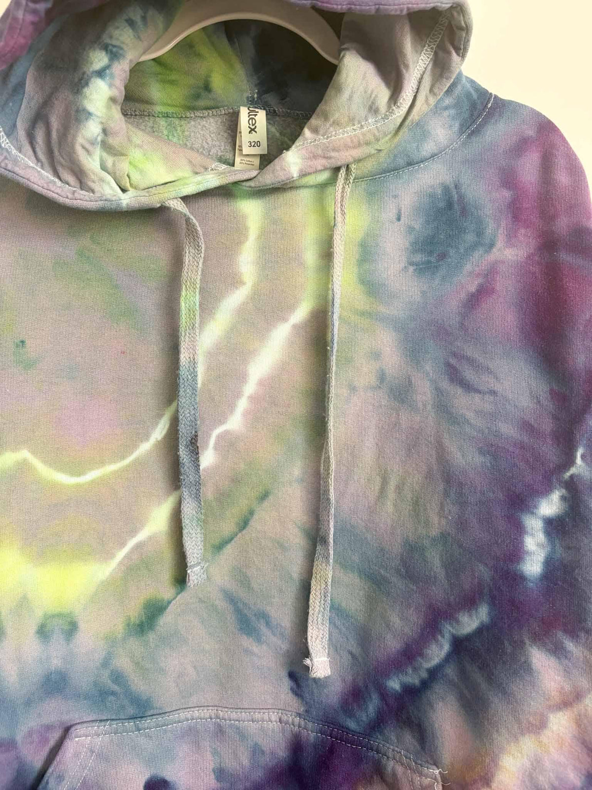 Close up of hood, tag, and drawstring on XL green and purple ice dye tie dye hoodie
