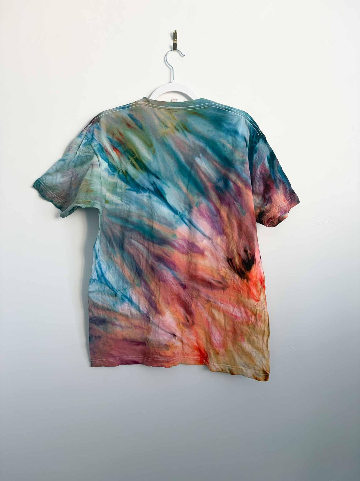L sunset fern fold ice dye tie dye tee hanging, back view, handmade one of a kind