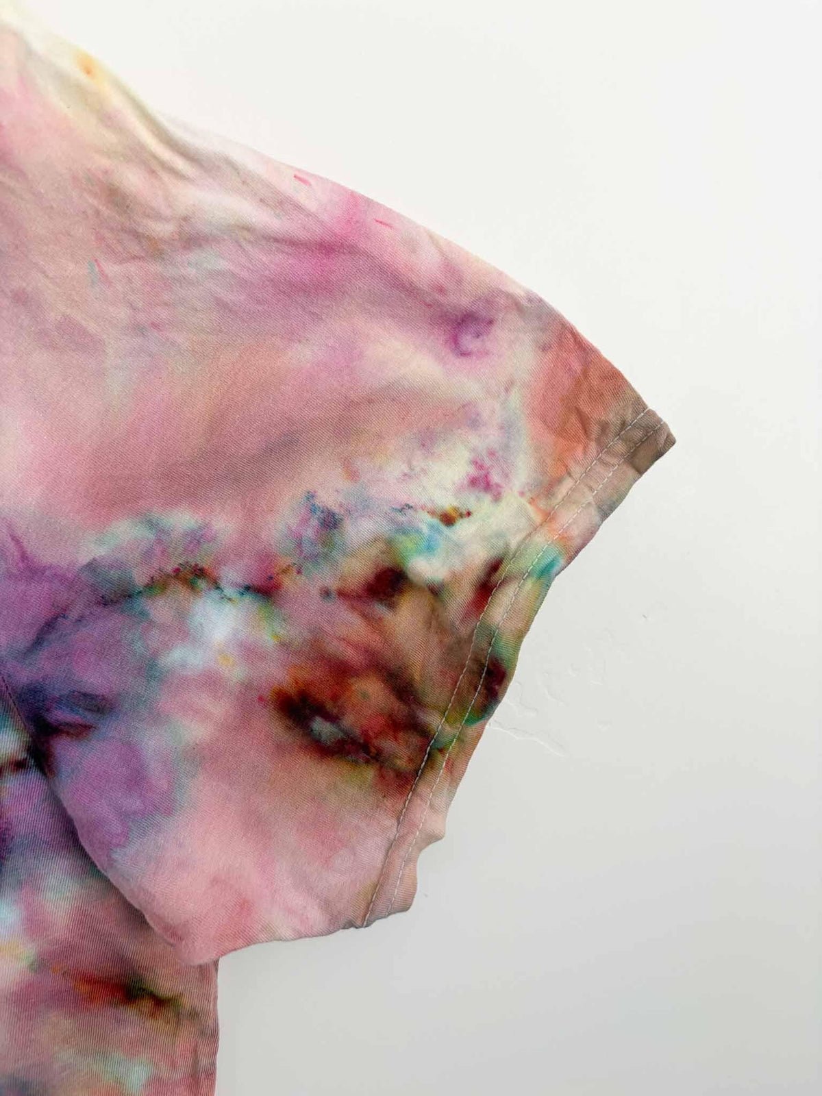 Close up of sleeve on 3XL pink and peach fern fold ice dye tie dye tee