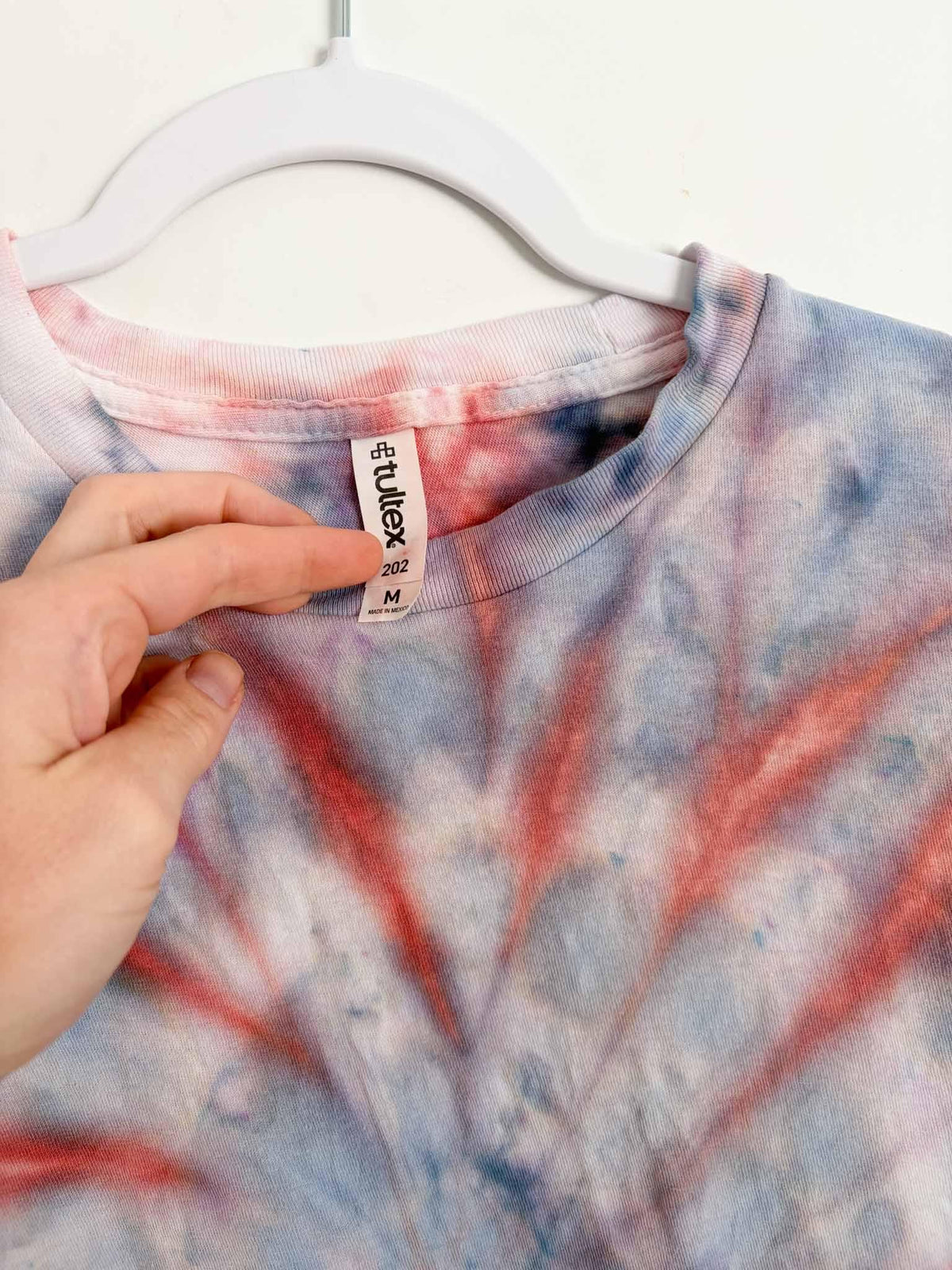 Tultex 202 M tag on red and blue spiral tie dye tee
