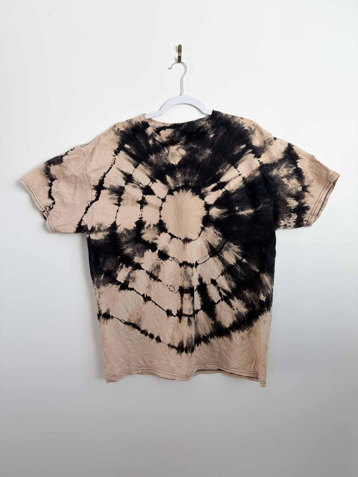 Front view of XL reverse tie dye bullseye shirt in black and tan
