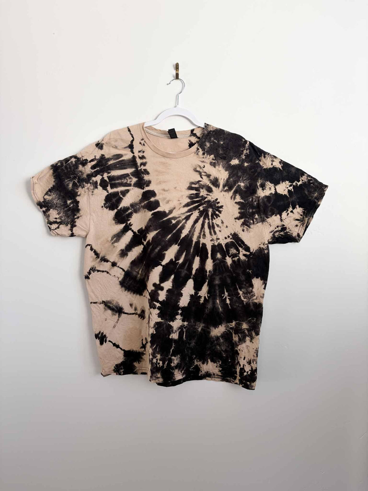 Front view of XL reverse tie dye spiral shirt in black and tan