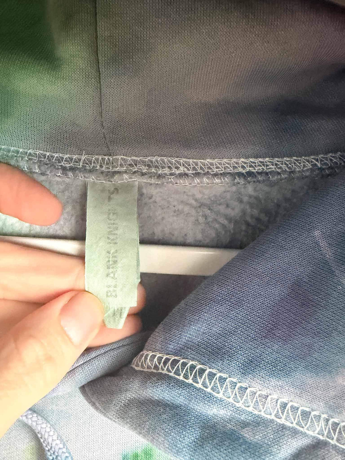 XL Blank Knights hoodie tag showing size on purple and green ice dye tie dye sweatshirt
