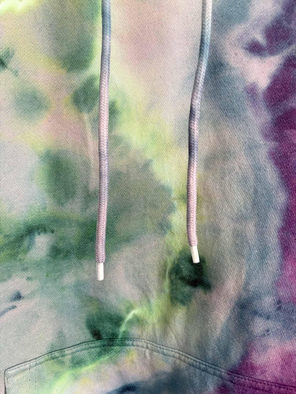 Close up of hood drawstring on XL green and purple ice dye tie dye hoodie
