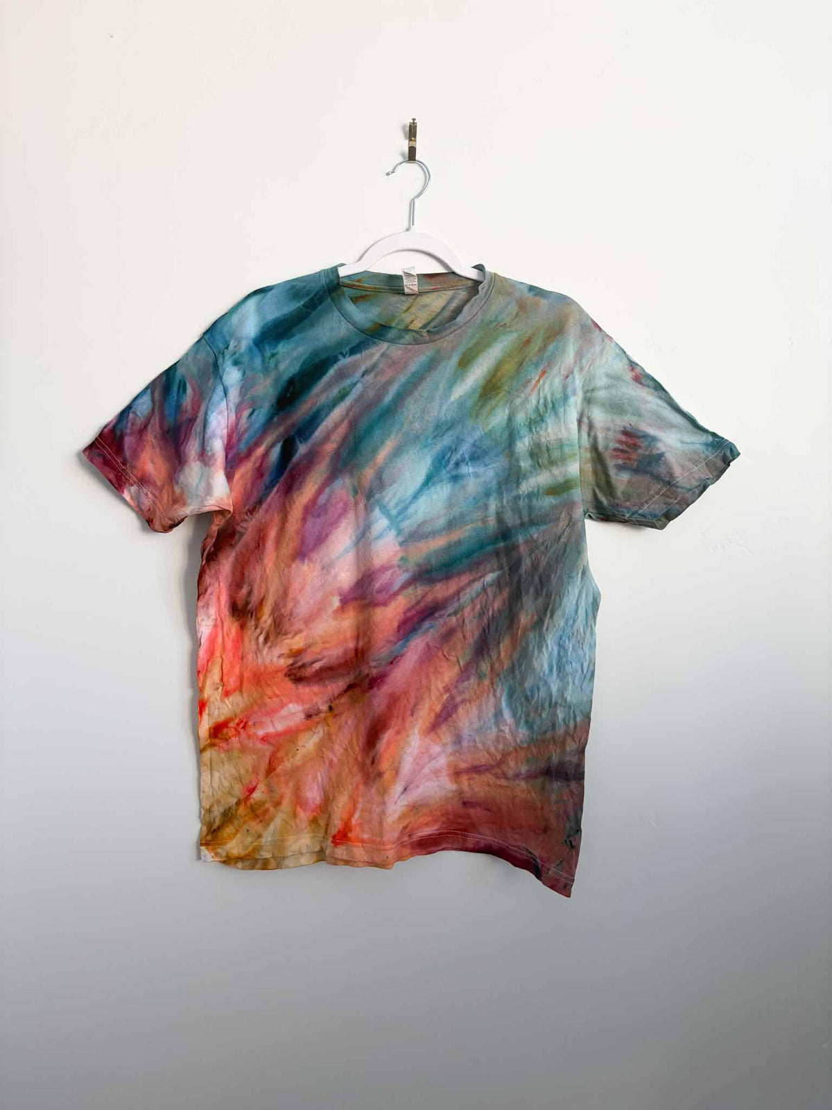 L sunset fern fold ice dye tie dye tee hanging, front view, handmade one of a kind