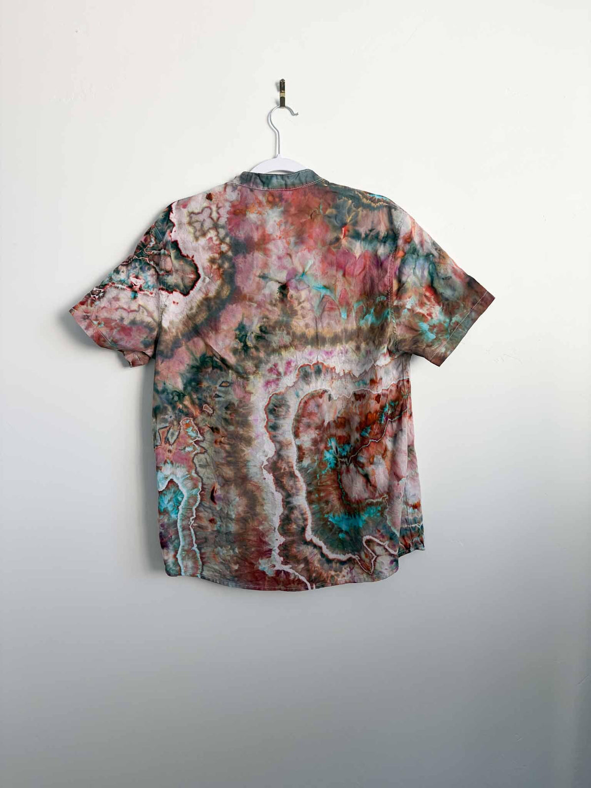 Back view of geode tie dye button down shirt showing turquoise and rust ring patterns